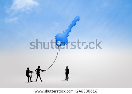 Silhouettes of business people pulling key with rope