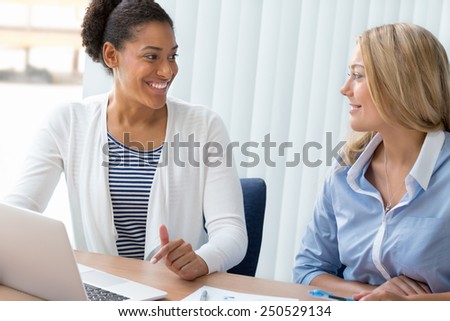 Two women working together in office