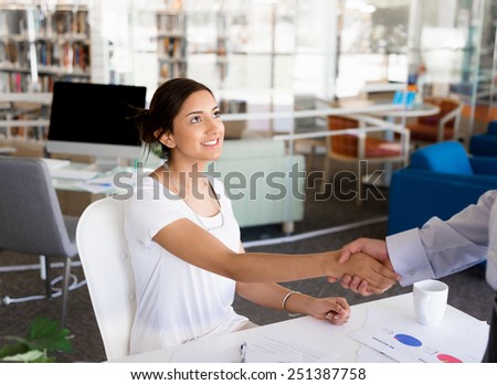 Young woman shaking hands with someone