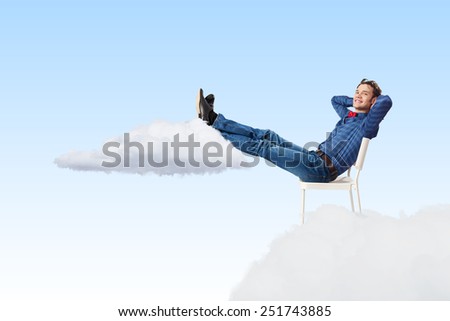 Young man sitting in chair with legs up and relaxing