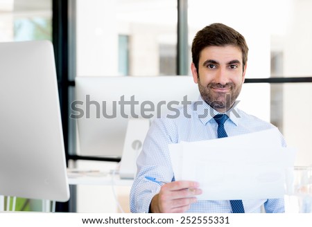 Young businessman in office working with papers