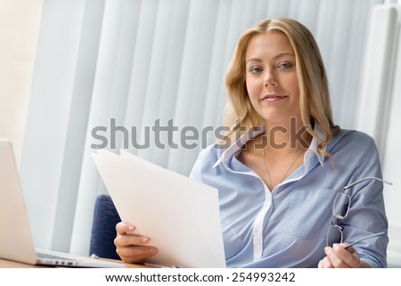 Businesswoman working with papers in offfice