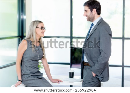 Shot of two collegues having a friendly conversation at the desk