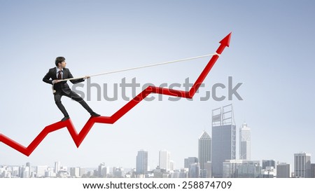 Businessman pulling arrow with rope and making it raise up