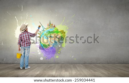 Boy of school age with yellow bucket and paint brush. Elements of this image are furnished by NASA
