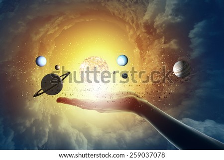 Close up of human hand with planet of sun system