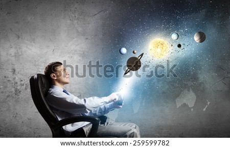 Young businessman using smart phone and planets of space spinning around