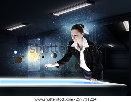 Young businesswoman and planets of space spinning around