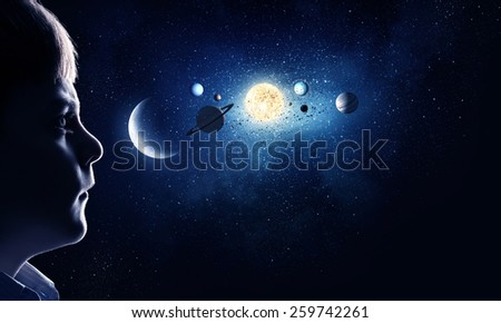 Cute boy of school age exploring space system