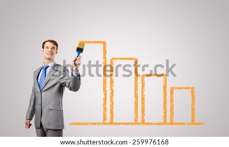 Handsome businessman with paint brush in hand