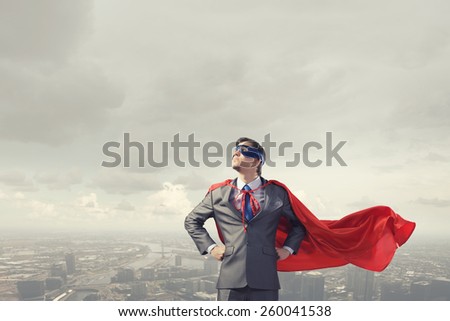 Young confident super businessman in mask and cape