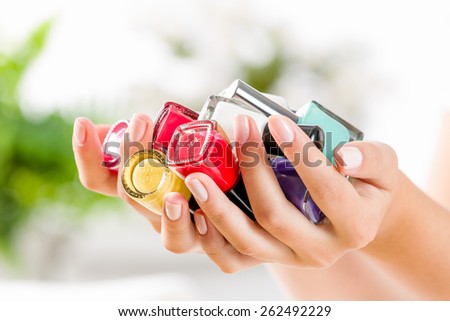 Close up of woman hands with nail polishes
