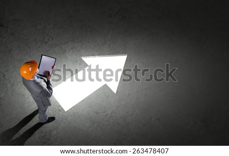Top view of businessman and business sketches on floor