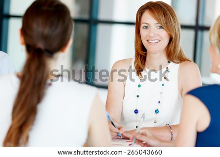 Businesswoman having discussion with collegues