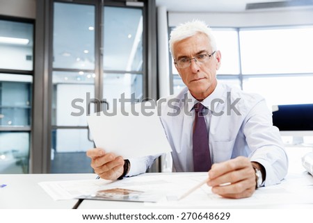 Businessman in office working with papers