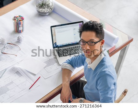 Young chineese engineer working in office
