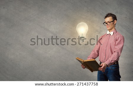 Young funny man with book in hands