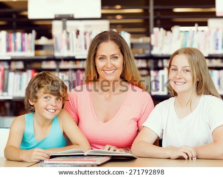 Mother with kids in library with books