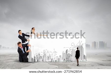 Small group of business people holding banner with construction project