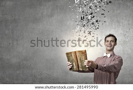 Young funny man with book in hands