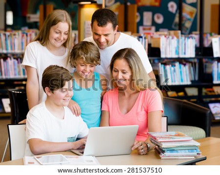 Family in library with notebook