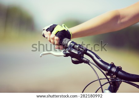 Close up of young woman riding a bicycle in a park