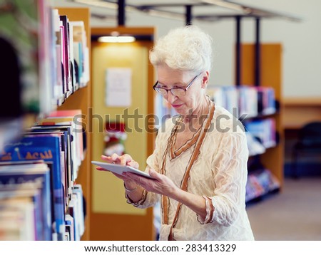 Elderly lady working with tablet