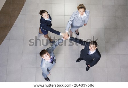Close up of business peoples hands on top of each other