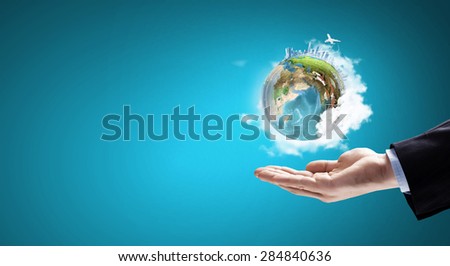 Close up of hand holding Earth planet. Elements of this image are furnished by NASA