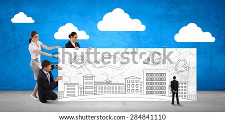 Small group of business people holding banner with construction project
