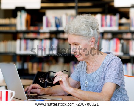 Elderly lady working with laptop