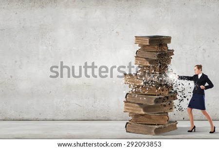 Young businesswoman and pile of old books