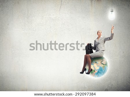 Happiness businesswoman sit on top of Earth planet. Elements of this image are furnished by NASA
