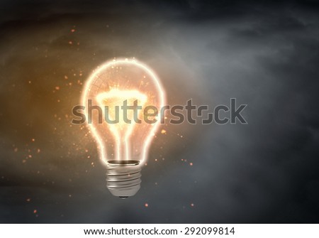 Light bulb turned on over black background