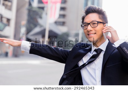 Businessman trying to catch a taxi in business cuty district