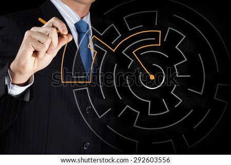 Close up view of businessman drawing way in labyrinth