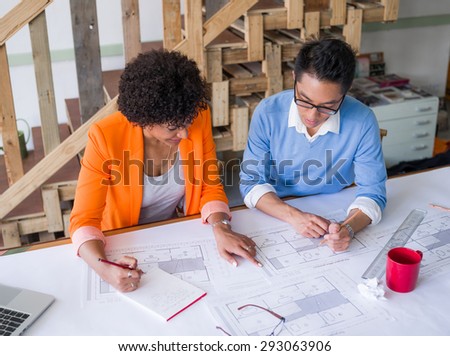 Two desingers working on a project together in office