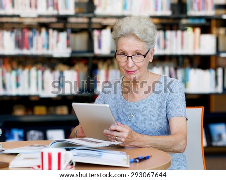 Elderly lady working with tablet