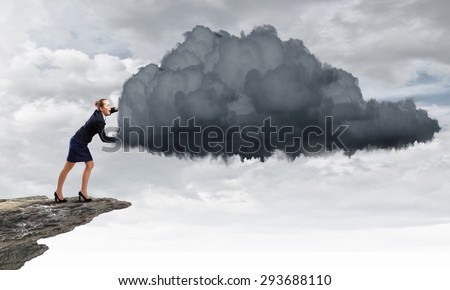 Attractive businesswoman pushing big cloud with effort