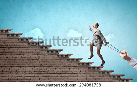 Young businesswoman with ropes on hands climbing ladder