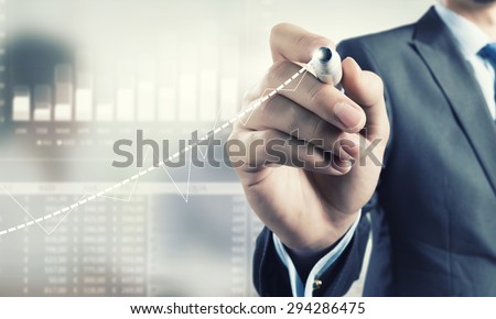 Businessman hand drawing increasing graph on media screen