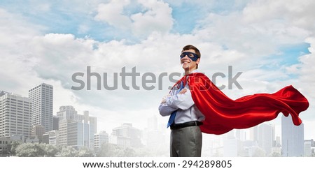 Young man in superhero costume representing creativity concept