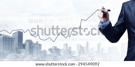 Close up of businessman drawing increasing graph with marker