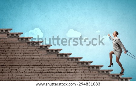 Young businesswoman with ropes on hands climbing ladder