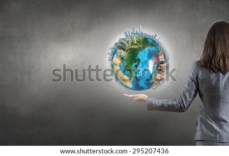 Close up of female hand holding our Earth planet. Elements of this image are furnished by NASA