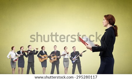 Young woman with book and playing different music instruments