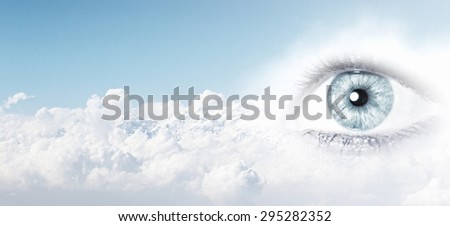 Female clear eye on blue sky background