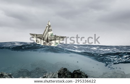 Paper ship floating on water on waves