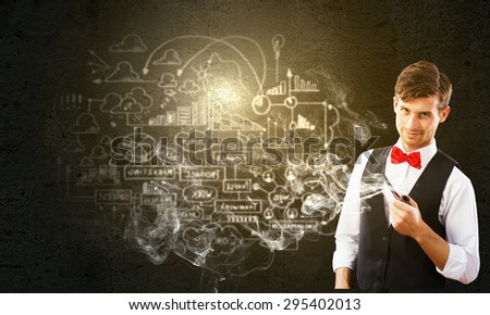 Handsome young businessman thinking over ideas and smoking pipe
