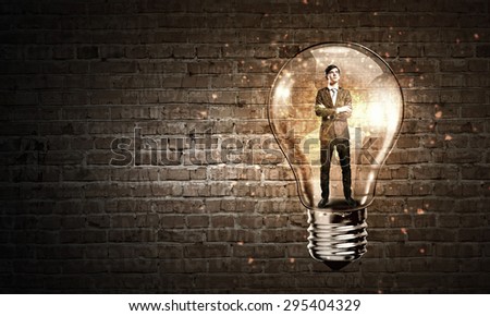 Man holding luminous idea inside light bulb